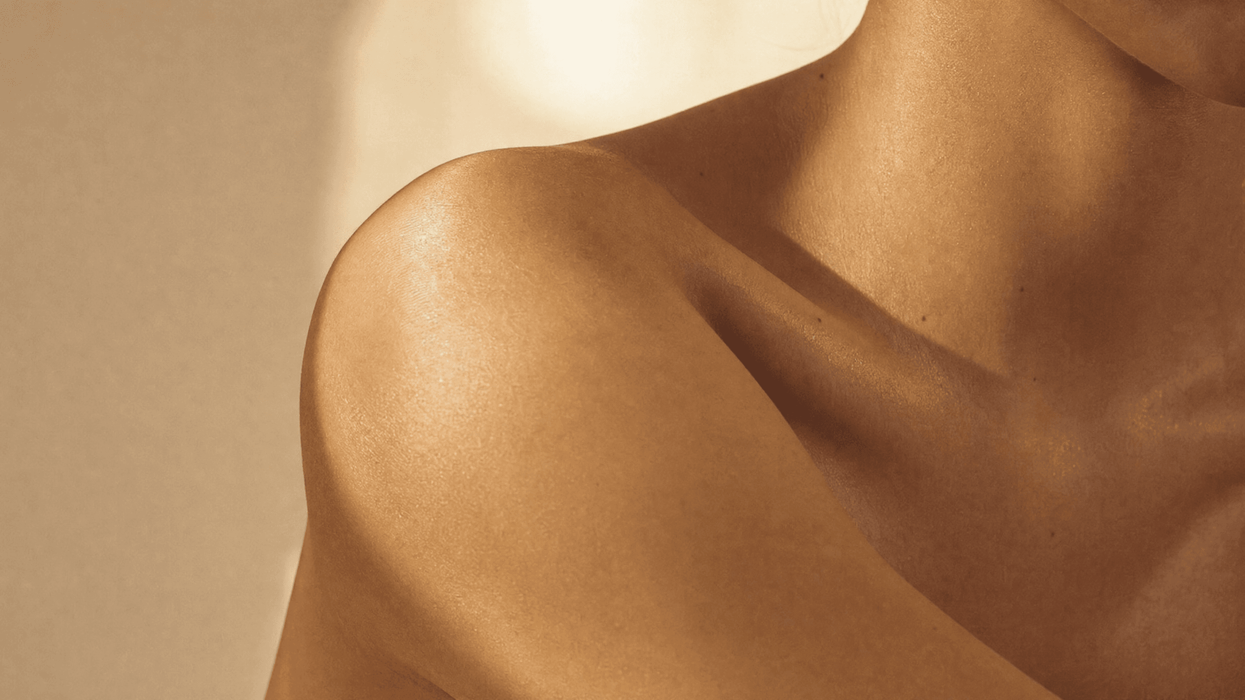 A luxurious editorial flat lay of rich body creams, oils, and exfoliants on a marble surface with soft winter lighting